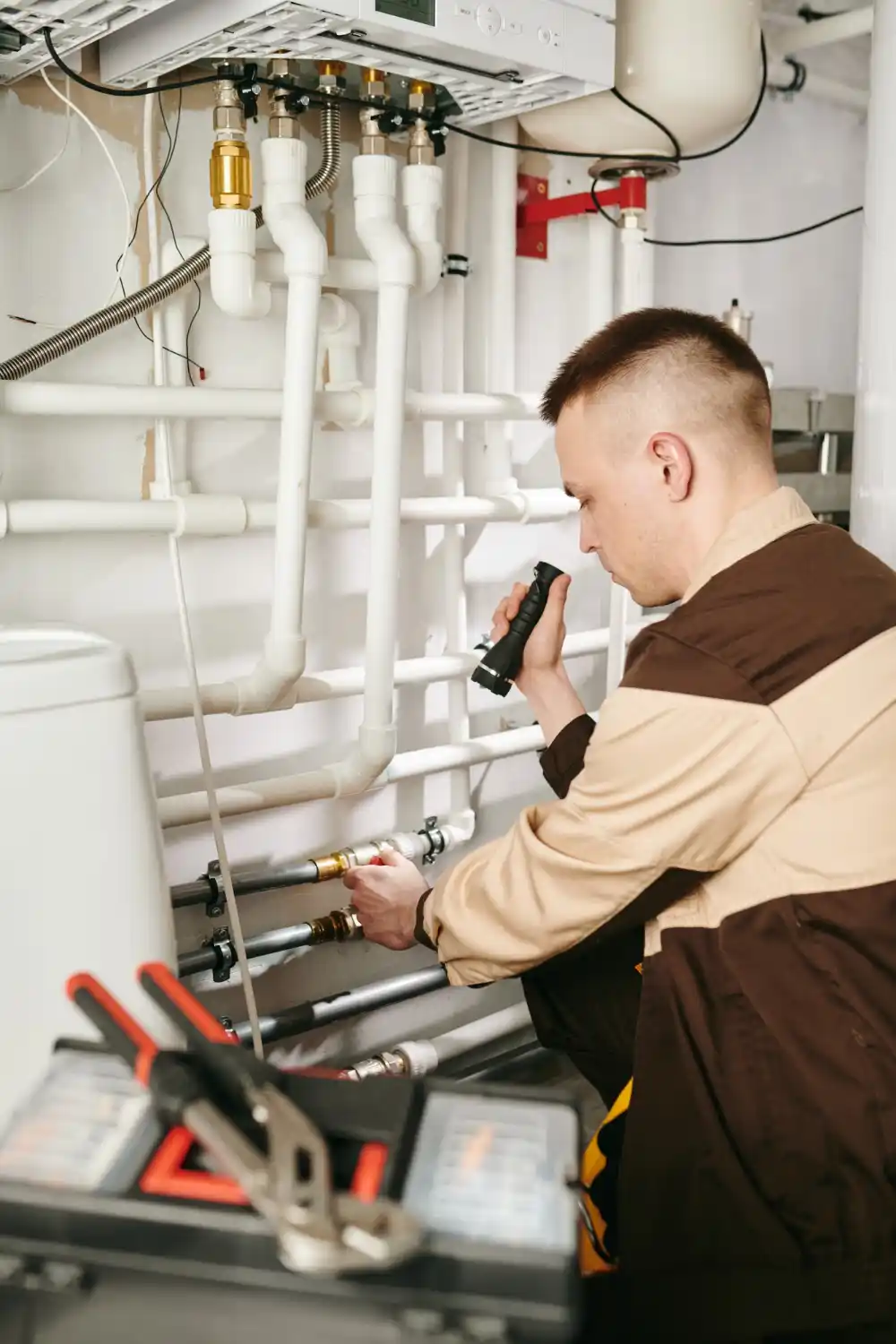Technician using non-invasive tools to inspect and detect hidden water leaks without damaging property