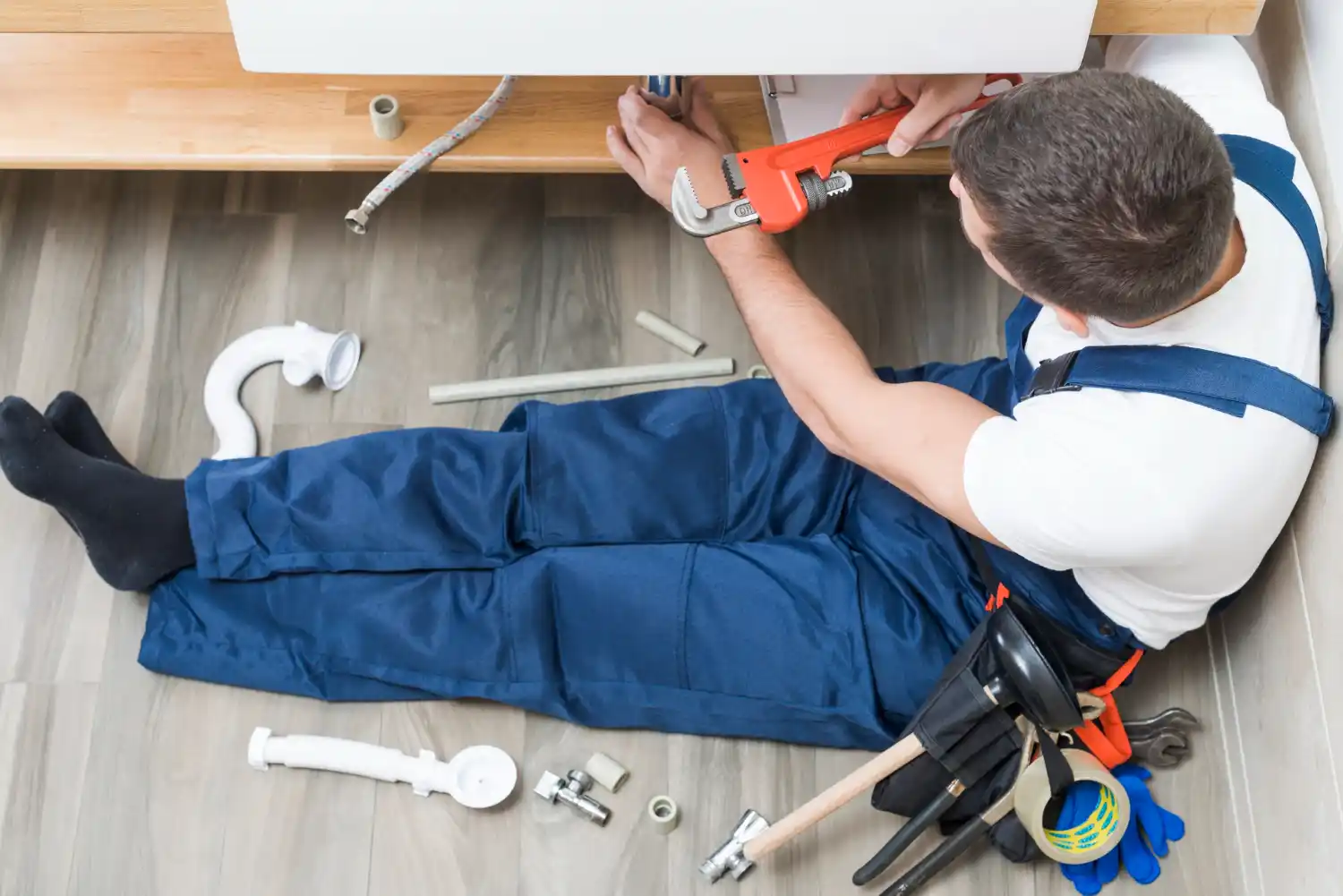 Professional plumber using acoustic and infrared tools for non-invasive leak detection