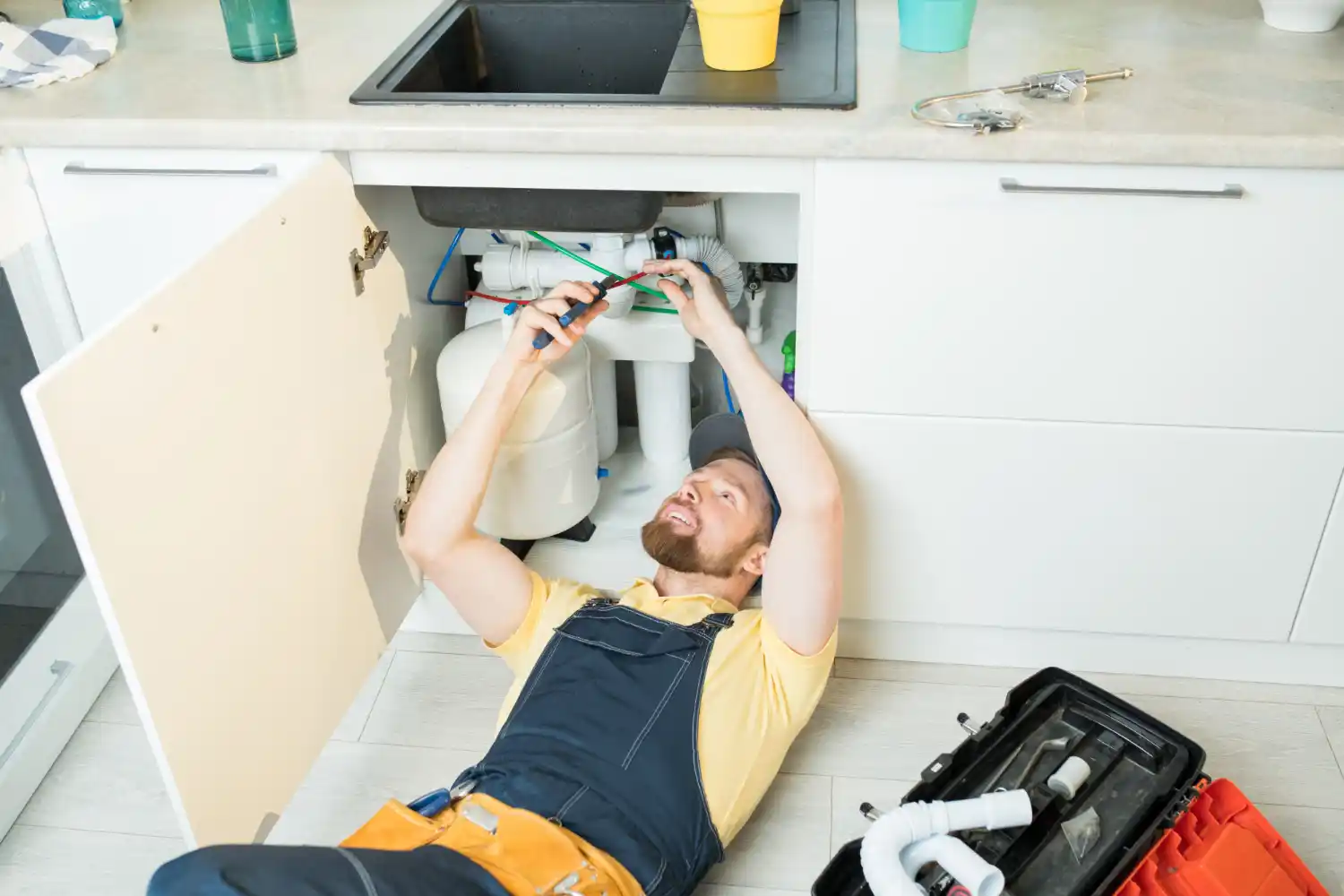 Professional plumber repairing household plumbing systems in a Dorking home